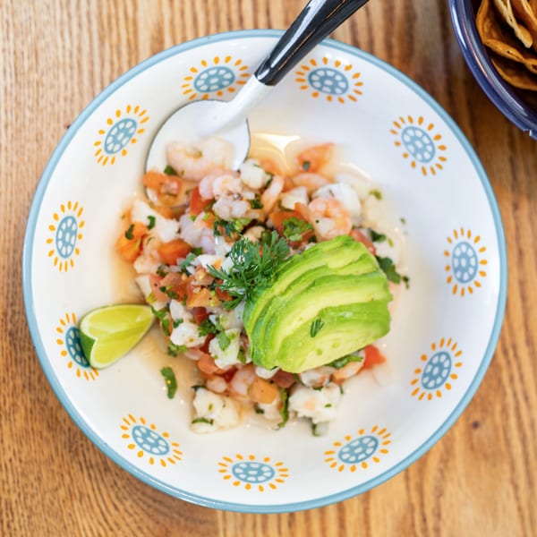 Polanquito's shrimp ceviche with avocado, lime, and cilantro in a decorative bowl.